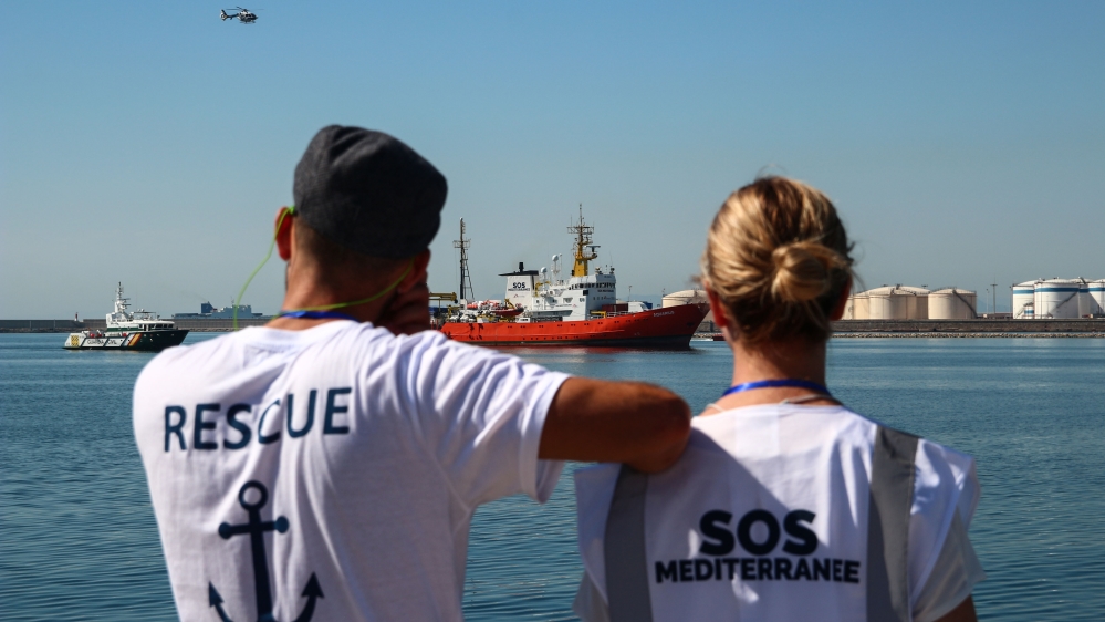 Volunteers with SOS Mediterranee, which operates the MV Aquarius jointly with MSF, watch as the ship enters Valencia harbour [Ruairi Casey/Al Jazeera]