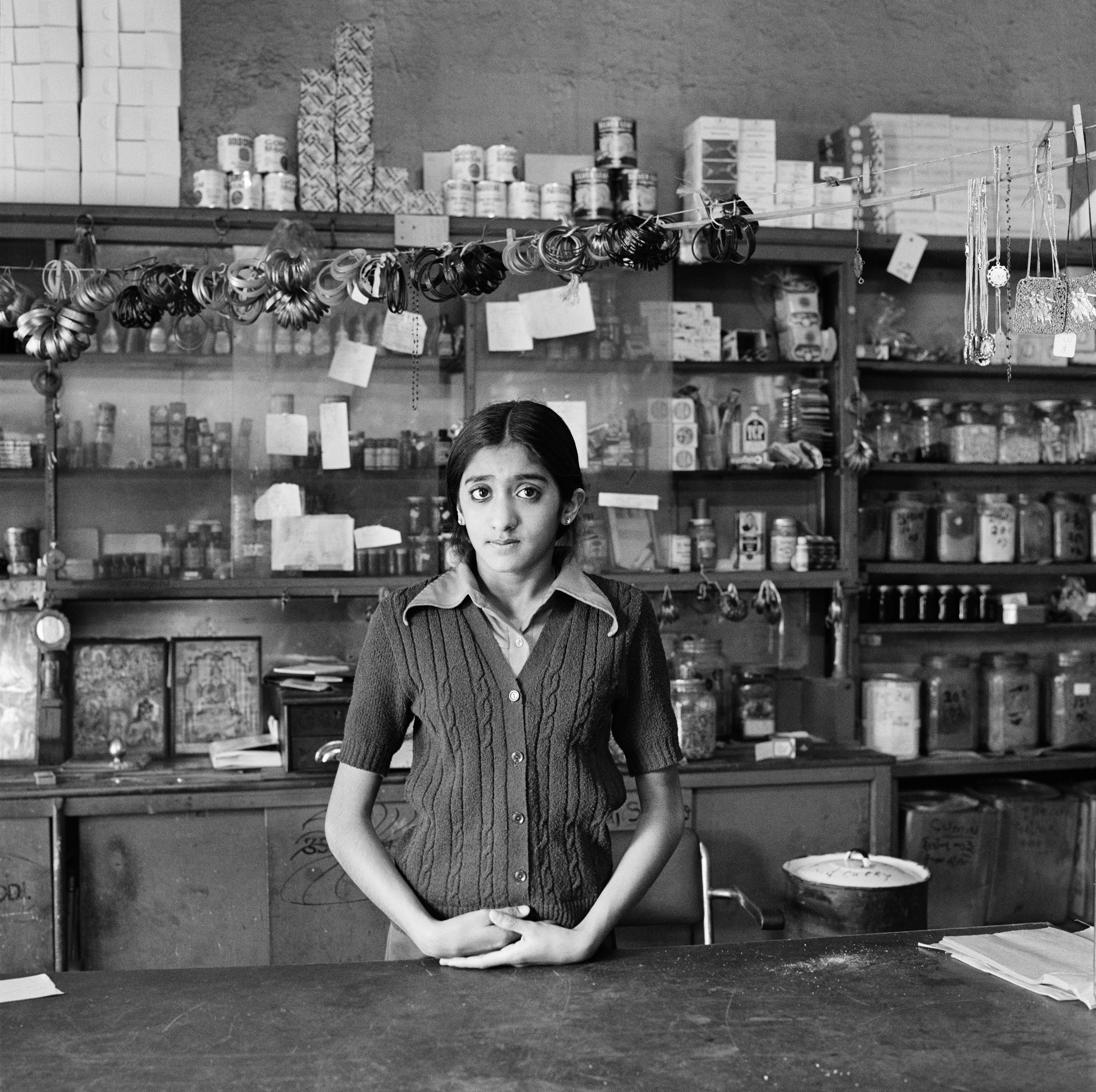 Yaksha Modi, daughter of Chagan Modi, in her father's shop before its destruction under the Group Areas Act, 17th Street, Fietas, Johannesburg, 1976 [Photograph by David Goldblatt]
