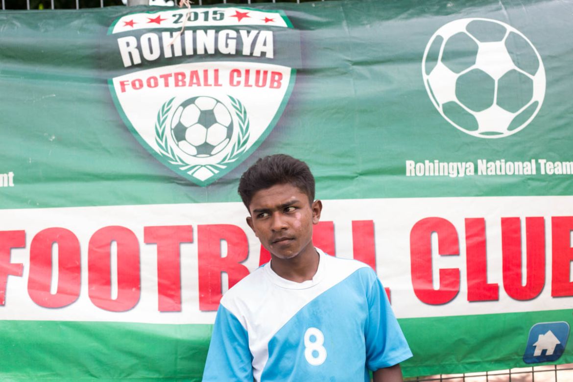A Rohingya teenager watches the match unfold. Many of the Rohingya children living in Malaysia lack access to formal education, those who go to school attending mostly community or religious schools.