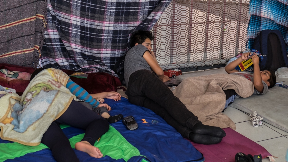 Carina Varera Gutierrez lies down for a nap with her son [Eline van Nes/Al Jazeera]