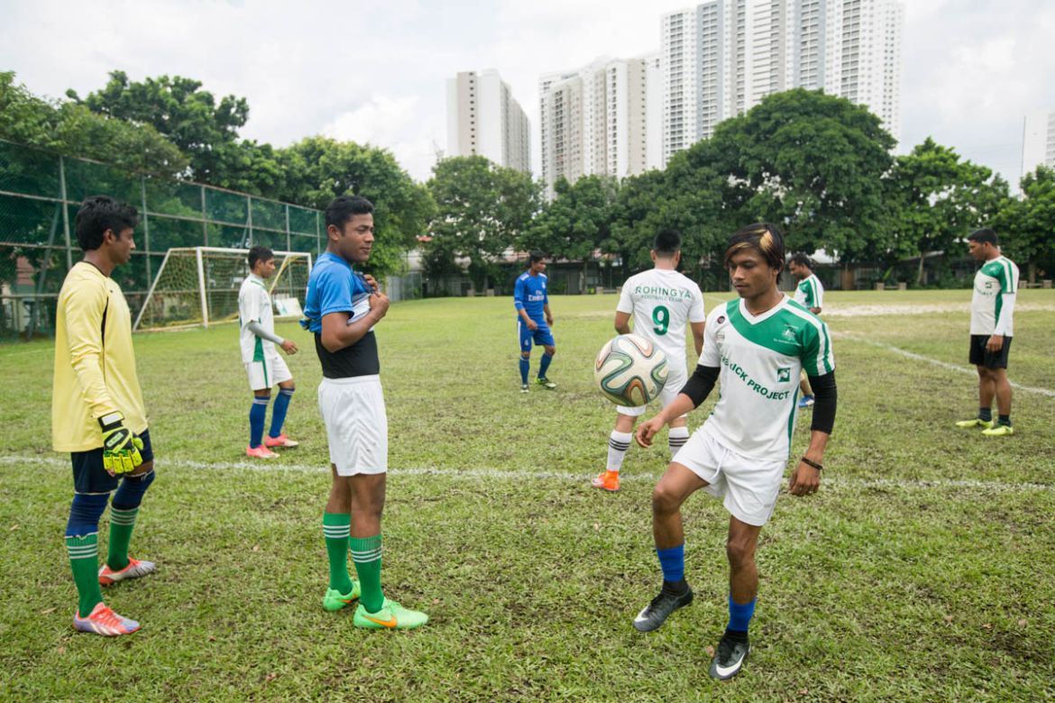 Players are warming up before the start of the match. Most of the players are practicing on a weekly basis, during the weekends or after their daily jobs.