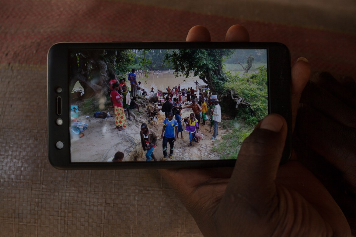A Cameroonian soldier shows a picture he took on his phone. In the morning of the13th of June 2018, 90 CAR refugees have crossed the Bombe river to reach Cameroon. Some refugees report being asked for
