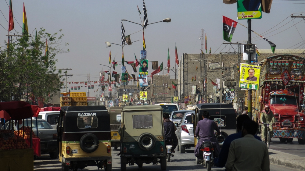 Political party flags on a main road in Balochistan's provincial capital, Quetta [Asad Hashim/Al Jazeera]