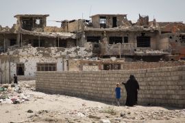 Picture 1 A mother and her daughter walk back to their neighbourhood in West Mosul. Destruction this area is everywhere. Rubbles and explosive remnants litter the streets and crumbled houses. Photo: