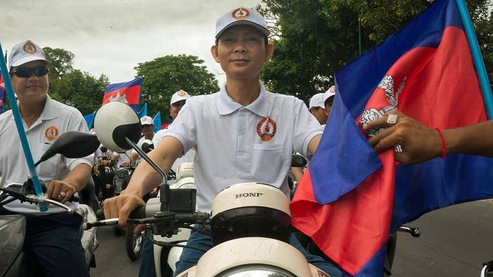 A young CPP supporter at a rally in Phnom Penh on July 22 [Nathan A Thompson/Al Jazeera]
