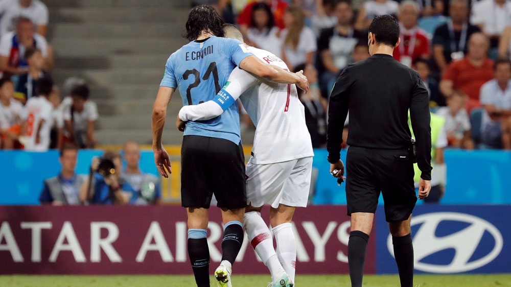 Cavani was helped off the pitch by Ronaldo after sustaining an injury [Toru Hanai/Reuters]