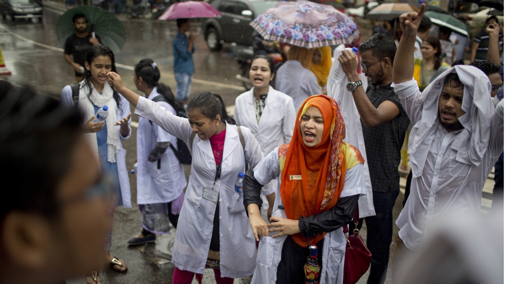Bangladeshi students shout slogans as they block a road during a protest in Dhaka [A. M. Ahad/Bangladesh]