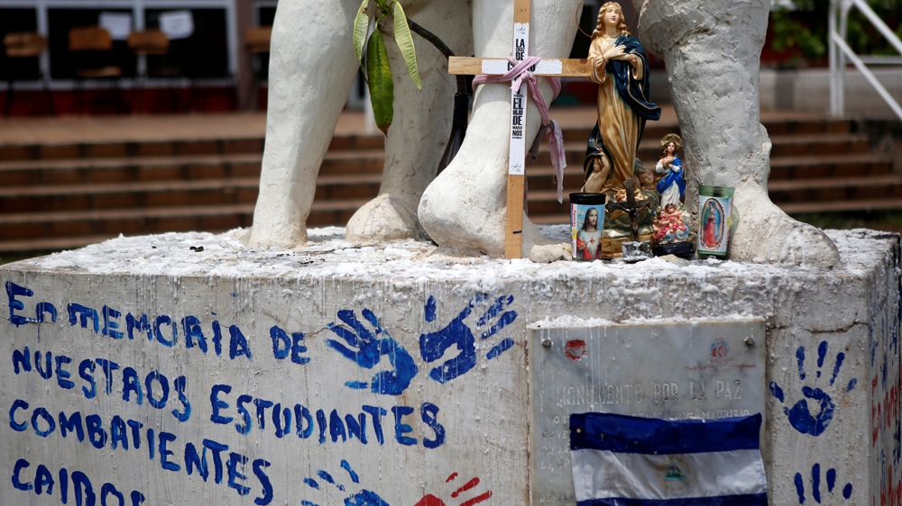 A sign reads: 'In memory of our fallen student combatants' [File: Oswaldo Rivas/Reuters]