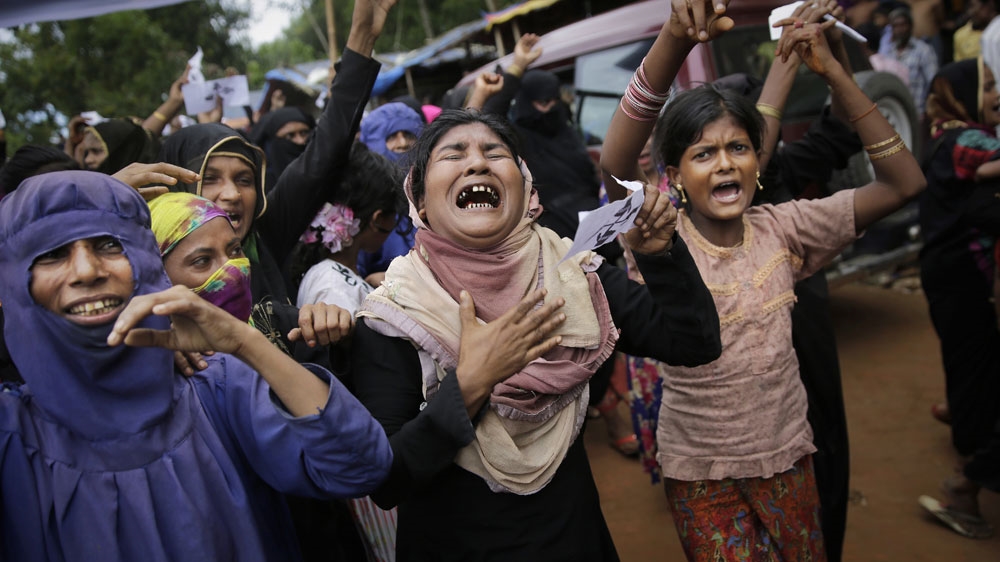 Rohingya women at Kutupalong refugee camp in Bangladesh cry during a protest rally to commemorate the first anniversary of Myanmar's crackdown [File: Altaf Qadri/The Associated Press]