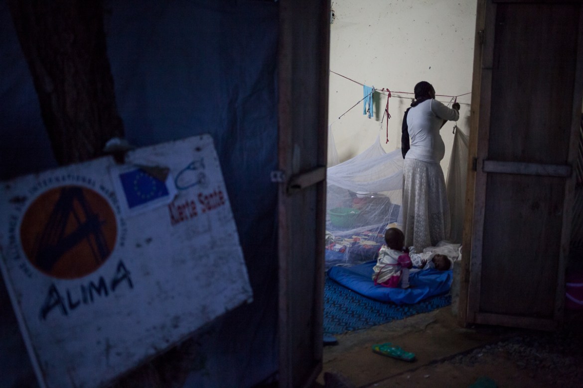woman hangs her mosquito net overnight in the transition section before she leaves the hospital. The malnutrition section of the Chad-China Friendship Hospital had 80 beds, but as patients slept on t