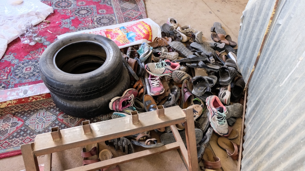 Athletes and staff at the Maiwand Wrestling Gym say piles of shoes left behind by the victims of ISIL attacks have become a common sight in Dasht-e Barchi [Ali Latifi/Al Jazeera]