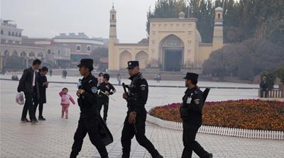 Uighur security personnel patrol near the Id Gah Mosque in Kashgar in Xinjiang in this 2017 photo [Ng Han Guan/AP]