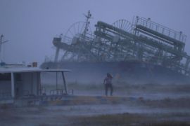 Ship washed ashore caused by Typhoon Trami is seen at a port in Yonabaru, on the southern island of Okinawa