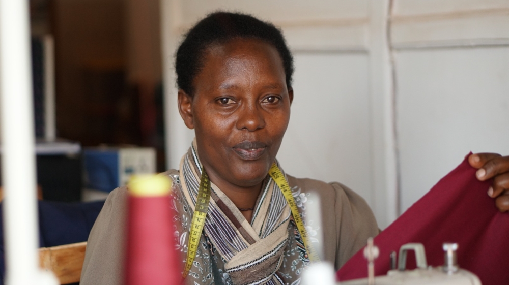 Eugenie Mukamunguga says the $68 she earns from the NWC each month has meant being able to walk [Azad Essa/Al Jazeera]