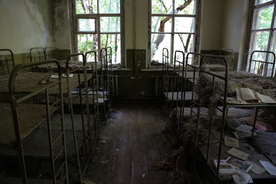 Bunk beds in an abandoned kindergarten in the village of Kopachi. [Blake Sifton/Al Jazeera]