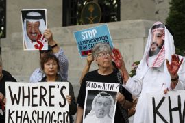 People hold signs at the Embassy of Saudi Arabia during protest about the disappearance of Saudi journalist Jamal Khashoggi, Oct. 10, 2018, in Washington [Jacquelyn Martin/AP]