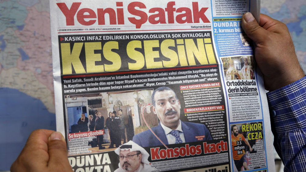 A man holds a Yeni Safak newspaper with the headline: '[To the Saudi consul] Shut up' [Burhan Ozbilici/AP]