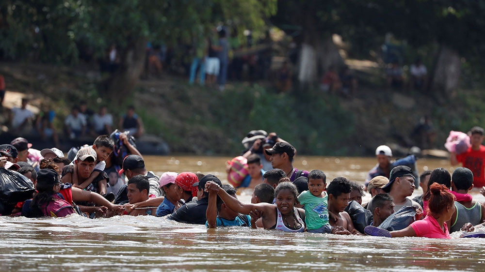 Central American migrants cross the Suchiate river, the natural border between Guatemala and Mexico, to reach the US [Carlos Garcia Rawlins/Reuters] 