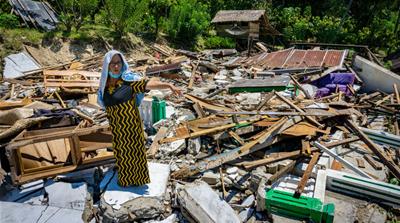 Ariyati stands in the ruins of her house a month after an earthquake struck Central Sulawesi [Ian Morse/Al Jazeera] 