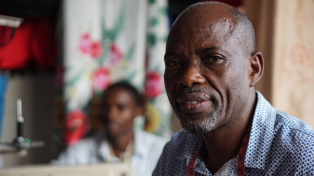 Ngoye Emmanuel, a tailor in Kigali, is pleased the government is supporting local creatives [Azad Essa/Al Jazeera] [Al Jazeera]