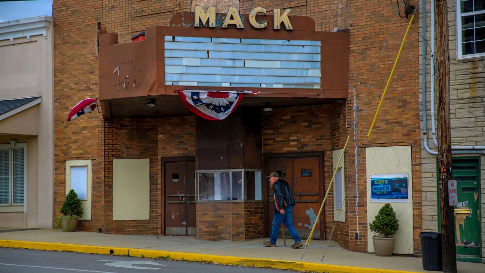 
A resident walks past an old theatre in Irvine, Kentucky, where 70 percent of voters opted for Trump in 2016 [Chris Kenning/Al Jazeera]
