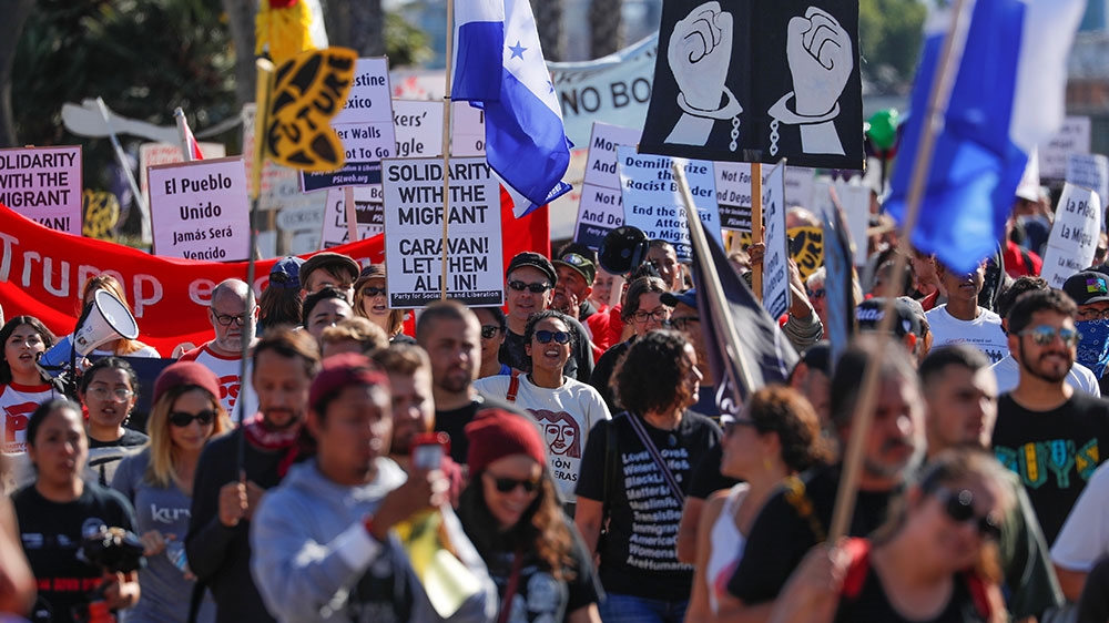 
Hundreds march in San Diego in solidarity with migrants and refugees in Tijuana [Mike Blake/Reuters]

