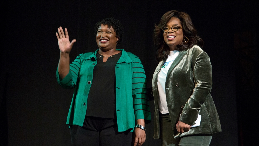 Oprah Winfrey takes part in a town hall meeting with Stacey Abrams (left) in Marietta [File: Christopher Aluka Berry/Reuters] 