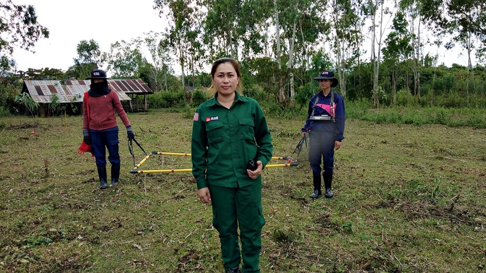 MAG operations manager Manixia Thor and other staff use a large-loop metal detector to locate UXO [Courtesy: MAG]