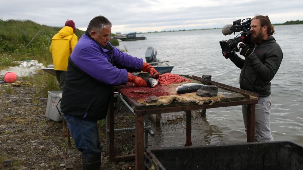 During the summer, residents are balancing jobs with the labour-intensive process of catching and storing salmon for the year [Showkat Shafi/Al Jazeera]  