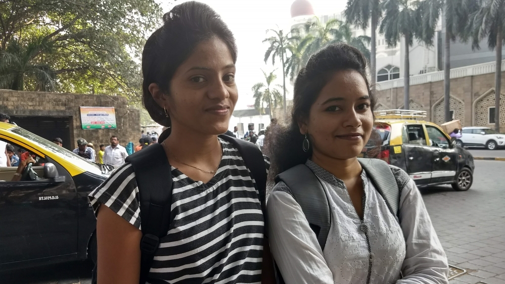 Patil, left, and Khandekar take a ferry every day to reach their university [Priyanka Borpujari/Al Jazeera]