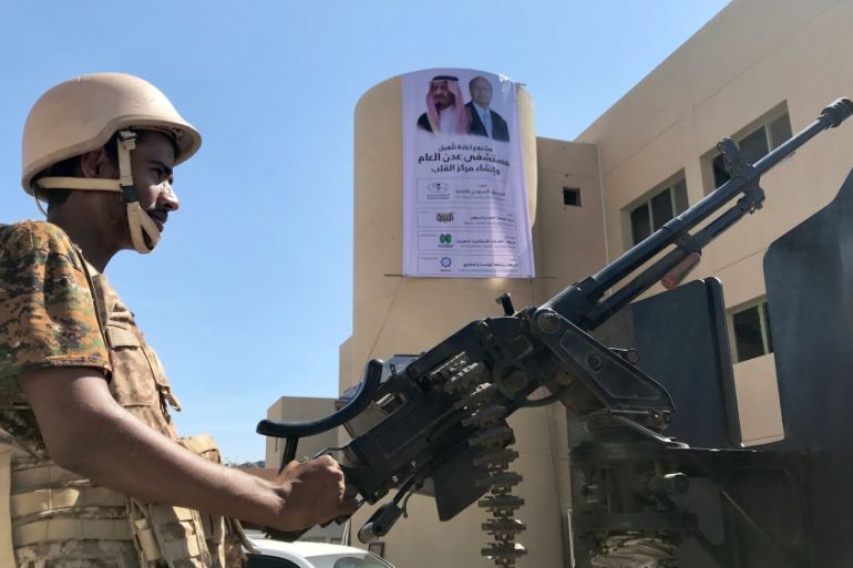 A soldier mans a machine gun on a patrol truck outside a hospital renovated by Saudi Arabia in Aden