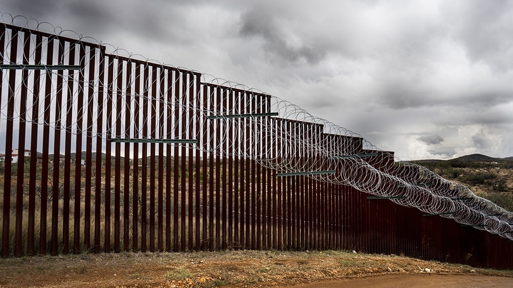 The existing border barrier includes a series of disparate and often unconnected fences and walls that span around one-third of the 3,201km border dividing the US and Mexico [Patrick Strickland/Al Jazeera]