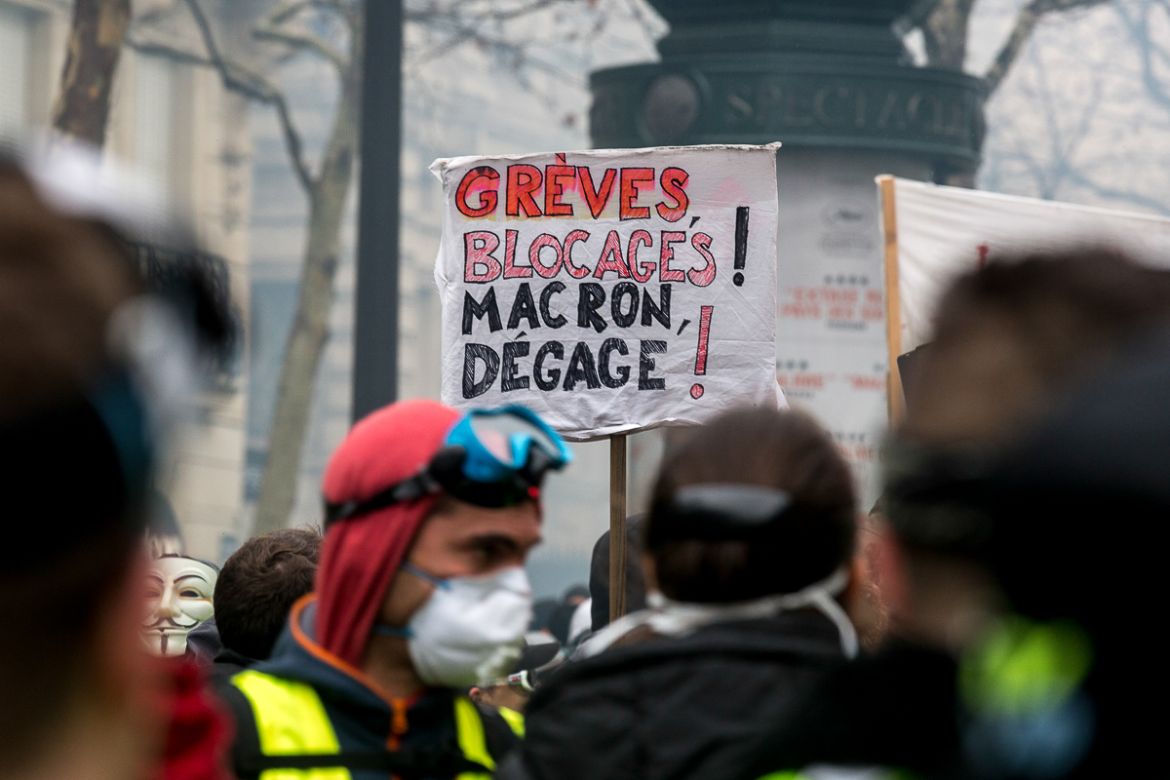 A banner demanding the resigning of President Macron is seen during a protest near the Champs ElysE`es called for by the i`Gilets Jaunesi^ movement on December 01, 2018 in Paris, France. Protesters sp