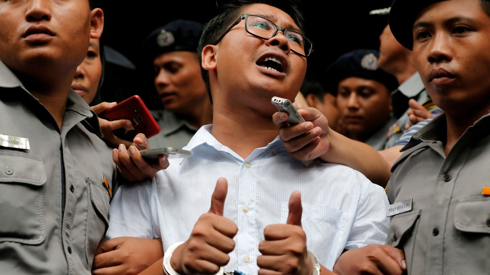 Wa Lone gives the thumbs-up as he leaves a Yangon court after being convicted of breaking the Official Secrets Act [Myat Thu Kyaw/Reuters]