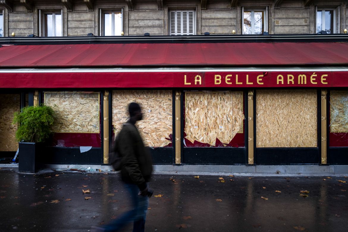 A man passes in front of the brasserie and cocktail bar i`La Belle ArmE`ei^ that was vandalized by extremists groups during last Saturdayi´s protests on December 03, 2018 in Paris, France. French Mini