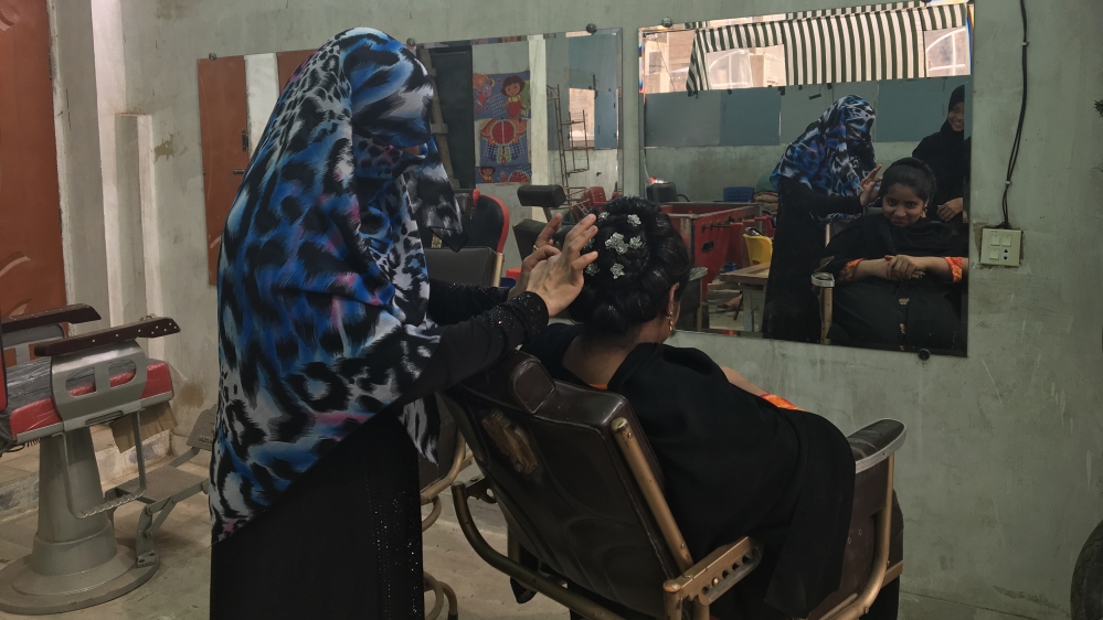 In addition to language classes, the cafe also teaches girls hairstyling techniques [Zehra Abid/Al Jazeera]