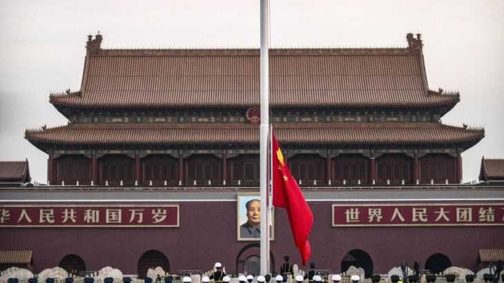A Chinese honor guard raises the flag at dawn on Tiananmen Square ahead of the opening session of China''s National People''s Congress (NPC) at the nearby Great Hall of the People in Beijing, Monday,