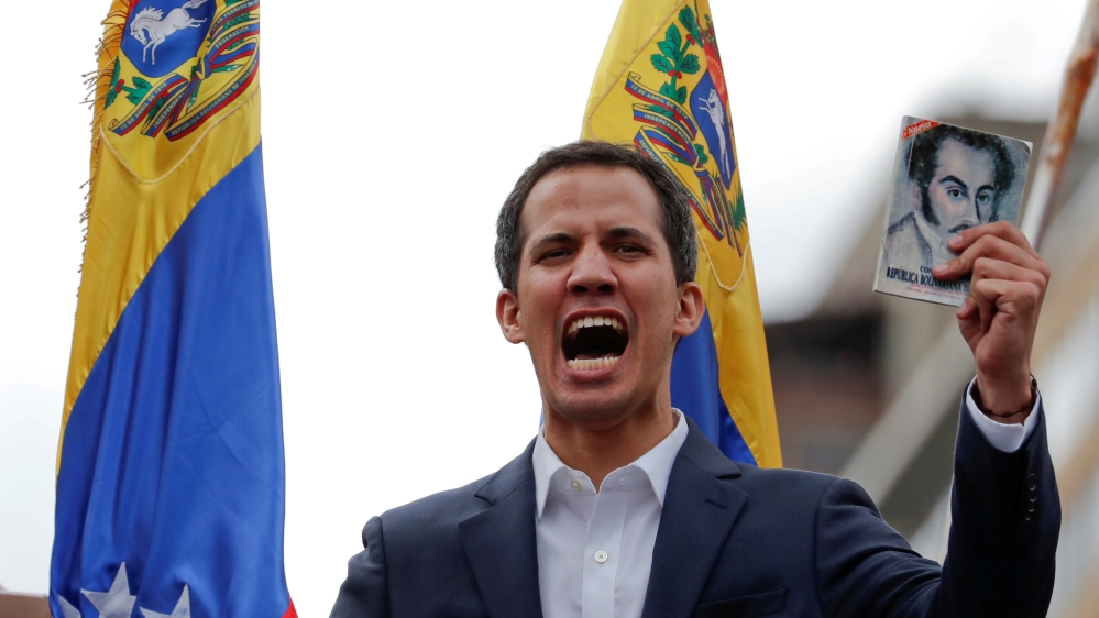 Juan Guaido holds a copy of Venezuela's constitution during a rally against President Nicolas Maduro's government [Carlos Garcia Rawlins/Reuters]