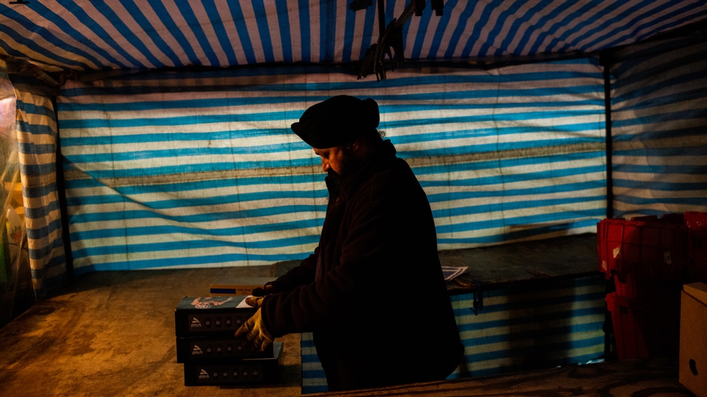 A trader from Rajasthan prepares to set up his stall early in the morning [Jose Sarmento Matos/Al Jazeera]