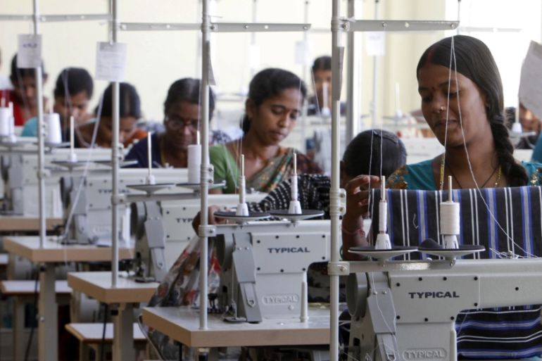 Indian workers sew at a garment factory on the outskirts of Hyderabad, India, Friday, Oct. 12, 2012.