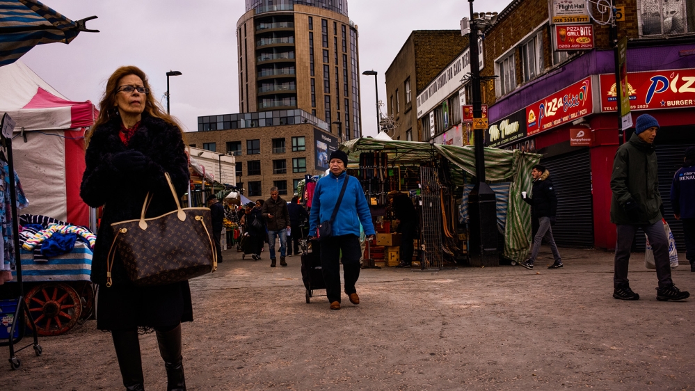 People walk through the Ridley Road Market in Dalston, East London [Jose Sarmento Matos/Al Jazeera]