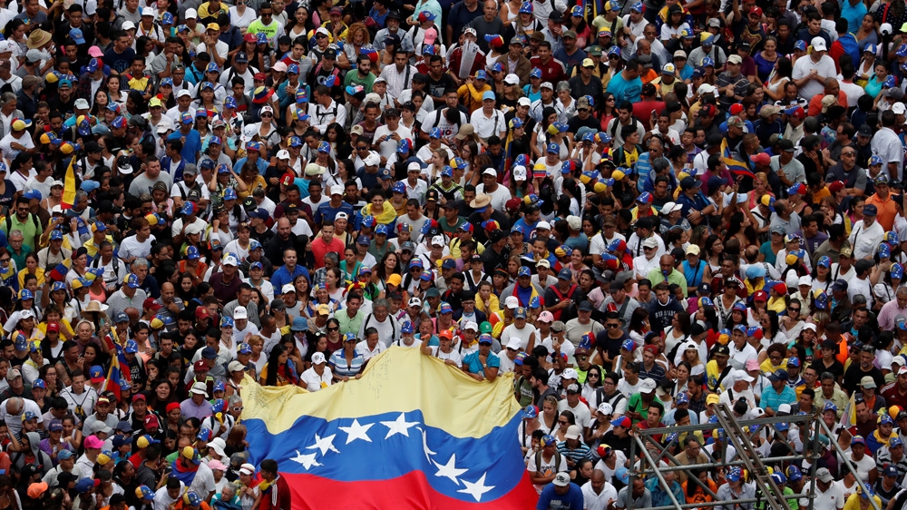 Opposition supporters take part in a rally against Venezuelan President Nicolas Maduro's government and to commemorate the 61st anniversary of the end of the dictatorship of Marcos Perez Jimenez in Caracas, Venezuela [Carlos Garcia Rawlins/Reuters]