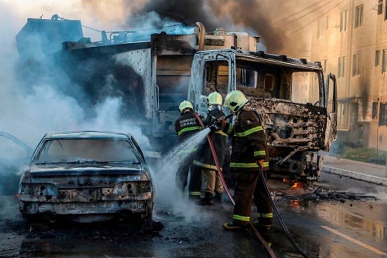 BRAZIL-CRIME-VIOLENCE-GANGS This picture released by O Povo shows firefighters putting out a burning truck and car during a wave of gang violence in Brazil''s northeastern Ceara state