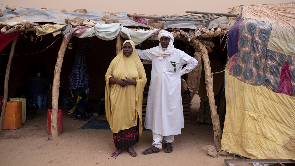 Fatimata Adiguini and her husband Mohammed Chegou in front of their family shelter in Agadez. They were both working in the migration business before a 2015 law declared their activities illegal. Chegou's ghetto hosted up to 100 migrants a day, waiting to cross to Libya [File: Francesco Bellina/Al Jazeera]