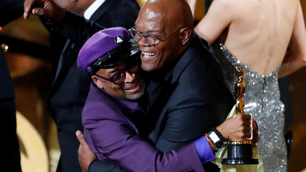Spike Lee (left) embraces Samuel L Jackson after winning the Best Adapted Screenplay award for BlacKkKlansman [Mike Blake/Reuters]