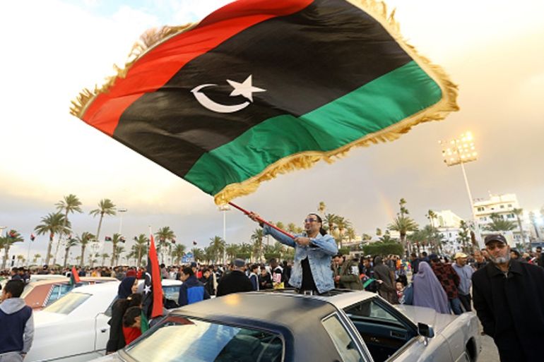 LIBYA-REVOLUTION-ANNIVERSARY Libyans carry national flags as they gather in the capital Tripoli''s Martyrs Square, to celebrate a day ahead of the eighth anniversary of the Libyan revolution,