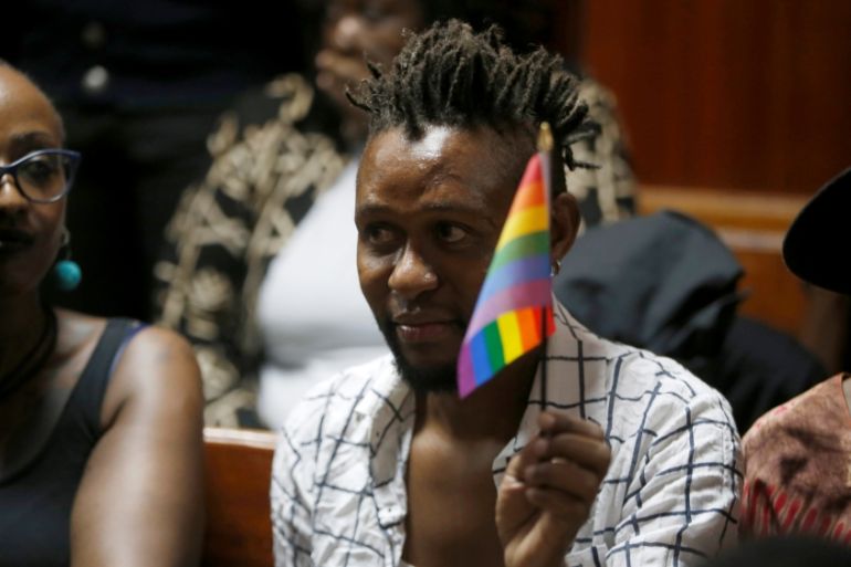 An LGBT activist holds the rainbow flag during a court hearing in the Milimani high Court in Nairobi in Nairobi