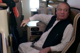 Ousted Pakistani Prime Minister Nawaz Sharif sits on a plane after landing at the Allama Iqbal International Airport