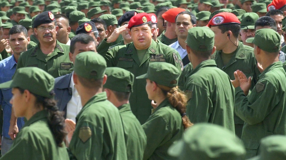 Venezuelan President Hugo Chavez, centre, salutes reservist soldiers as he arrives at a ceremony [File: Miraflores/AP] 