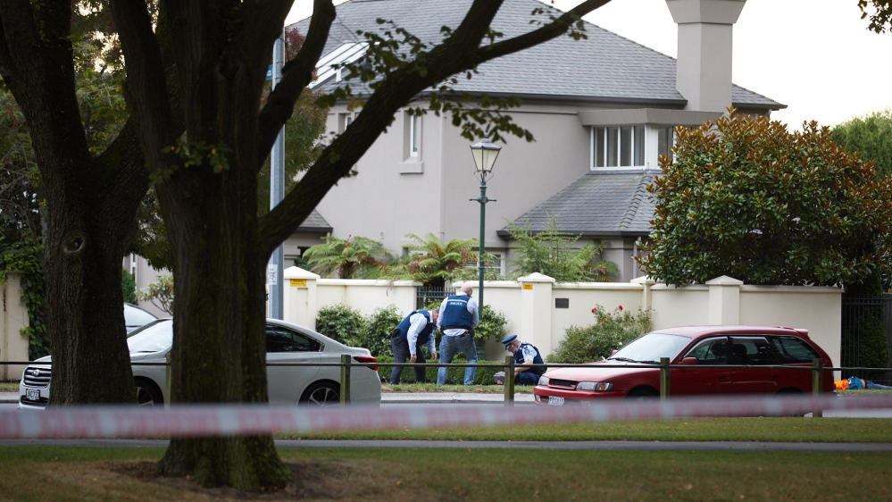 Police officers inspect the shooting site as dead body of a victim is seen on the ground behind of the car in front of Al Noor Mosque in Christchurch, New Zealand [Anadolu Agency]